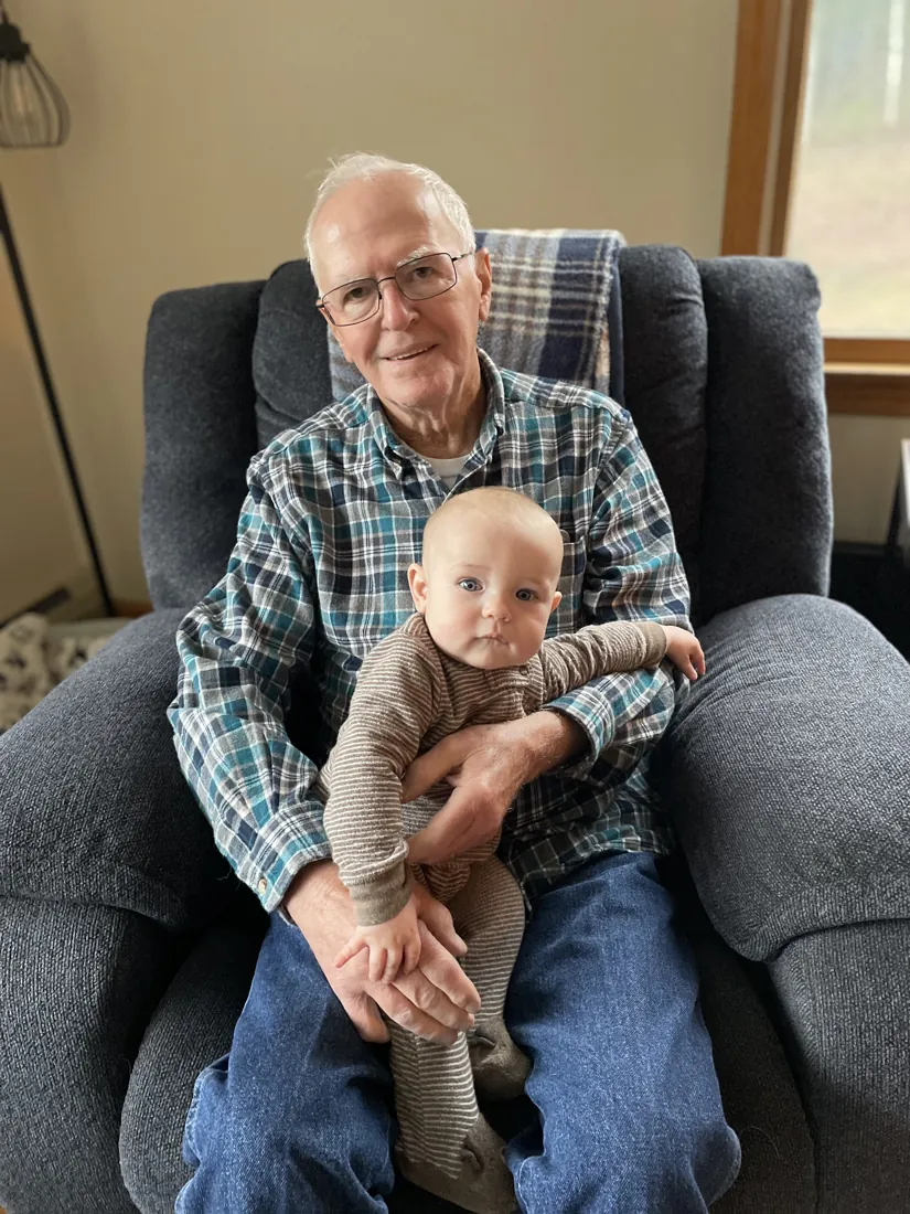 Robert holding a grandbaby