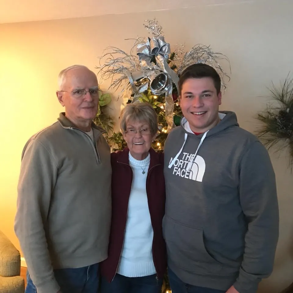 Robert and Patsy with a grandson by the Christmas tree