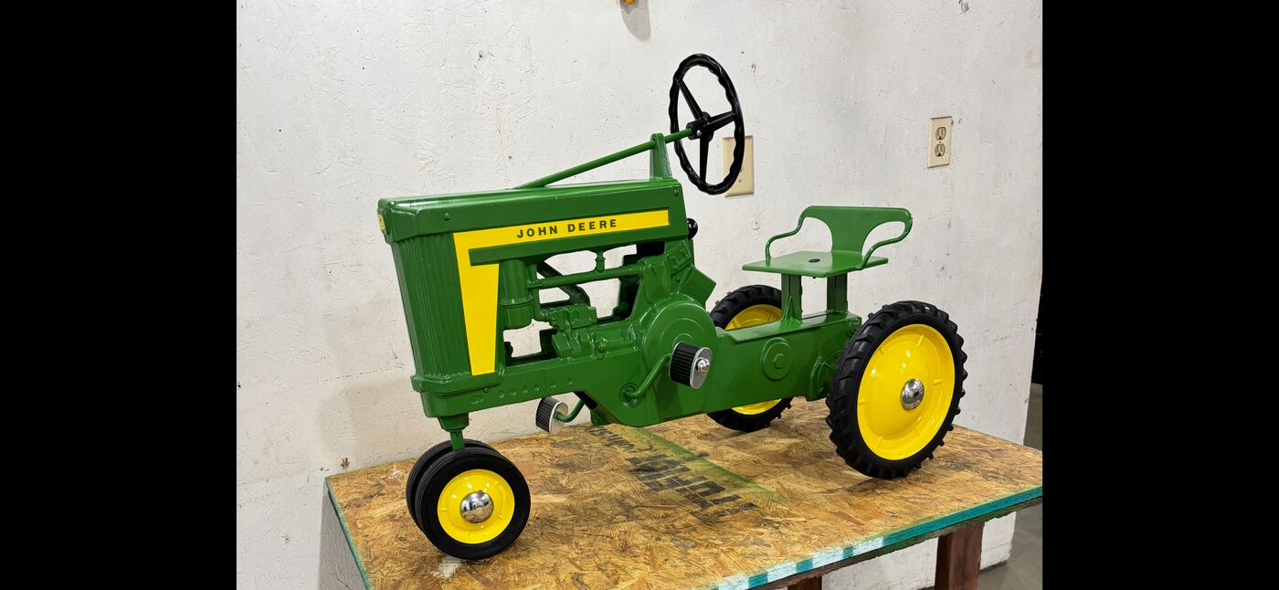 A fully restored John Deere pedal tractor