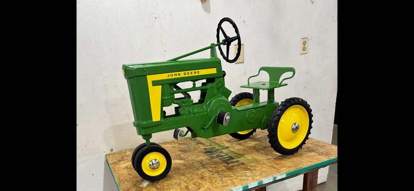 A fully restored John Deere pedal tractor