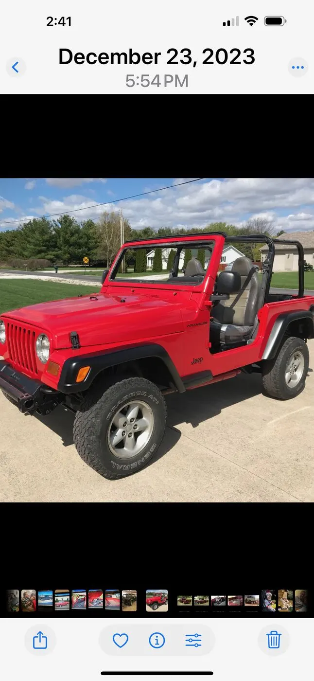 A restored red Jeep